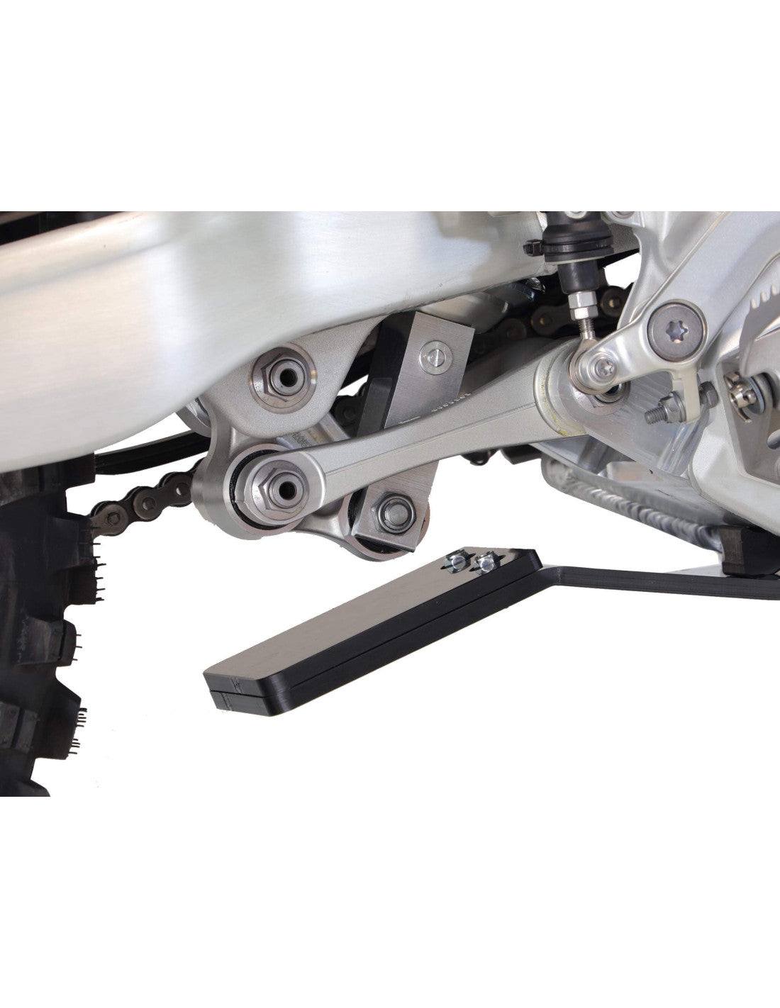 Close up view of the linkage guard of the black HDPE plastic skid plate for Triumph TF250-X and TF250-E